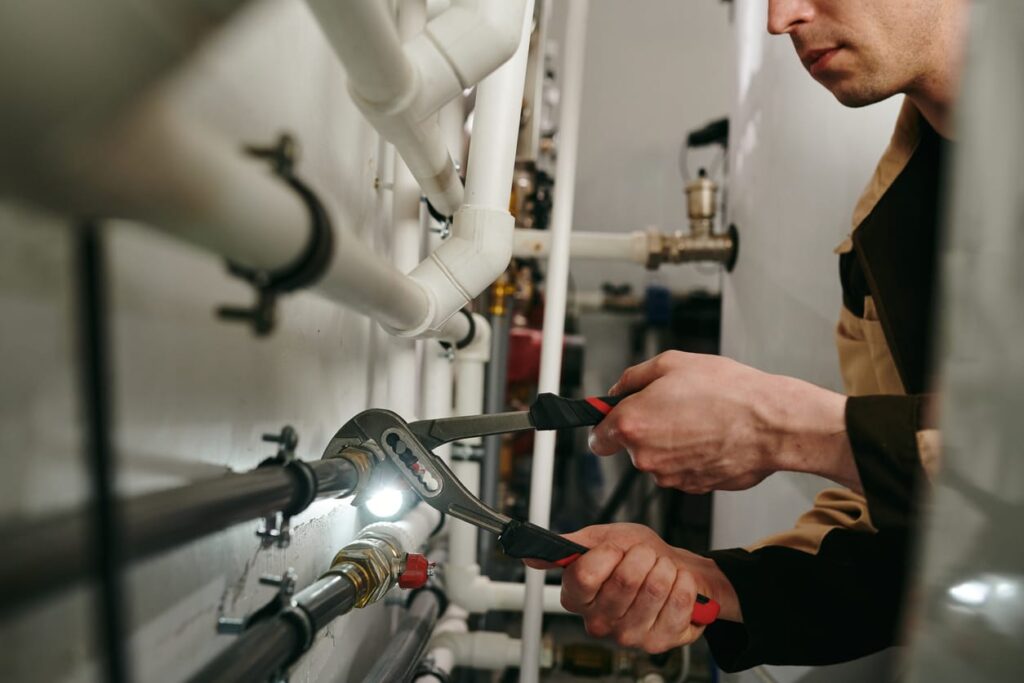 Plumbers maintaining commercial plumbing pipes in Peachtree City