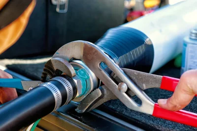 Technician tightening an industrial pipe connection in Peachtree City