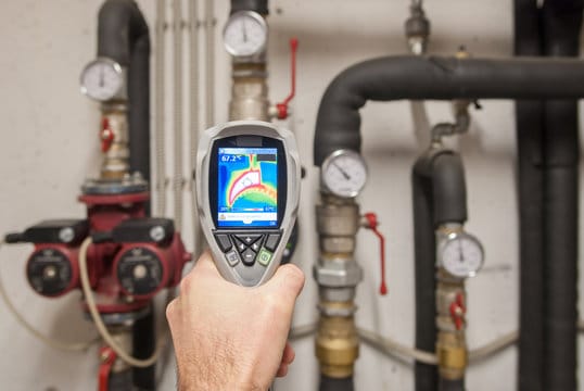 Plumber using a thermal imaging camera to inspect pipes in Peachtree City