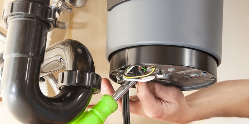 Technician repairing the heating element of a water heater in Peachtree City