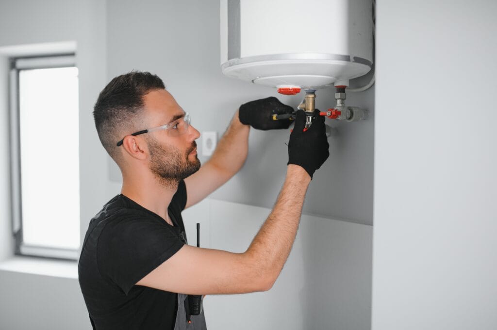 Technician performing water heater maintenance in Peachtree City